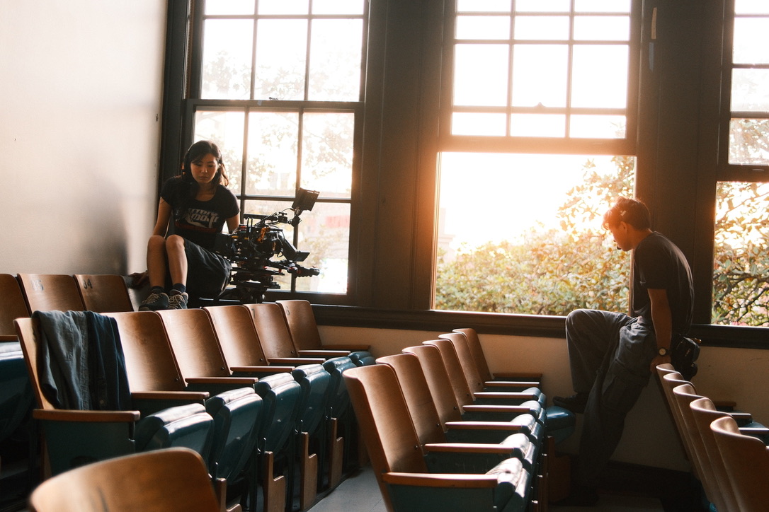 Crew sitting in theater seats with a camera rig