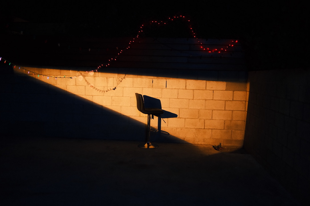 Empty chair on set under string lights