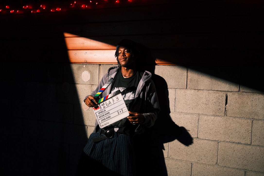Actor holding a clapperboard on set