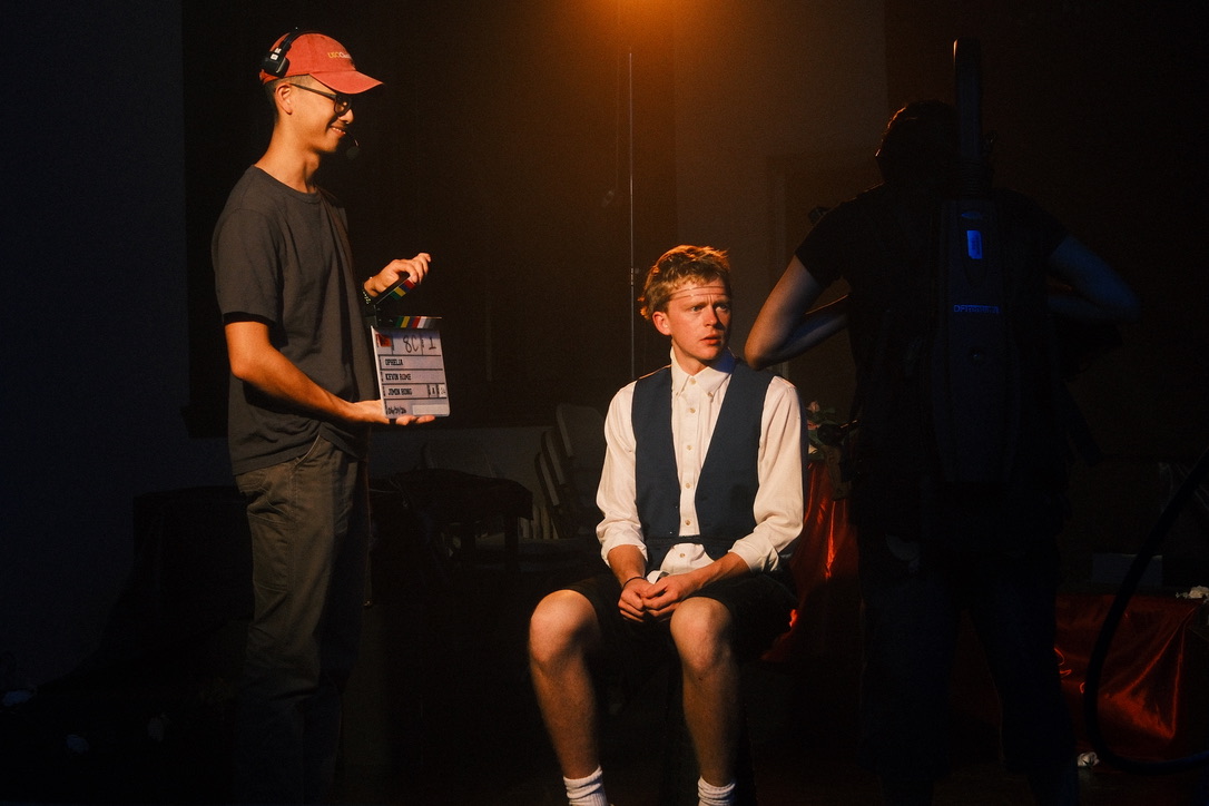 Actor sitting for a clapperboard slate between takes