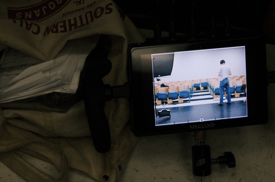 Camera monitor showing an actor in an empty theater