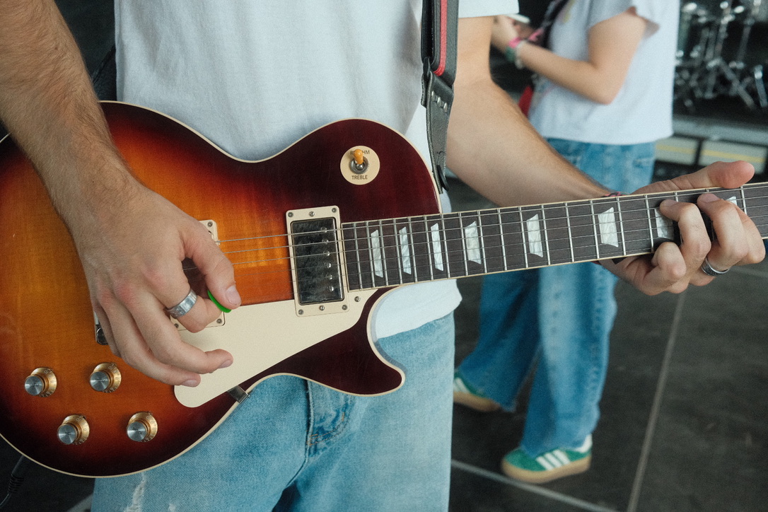 Close-up of hands playing an electric guitar