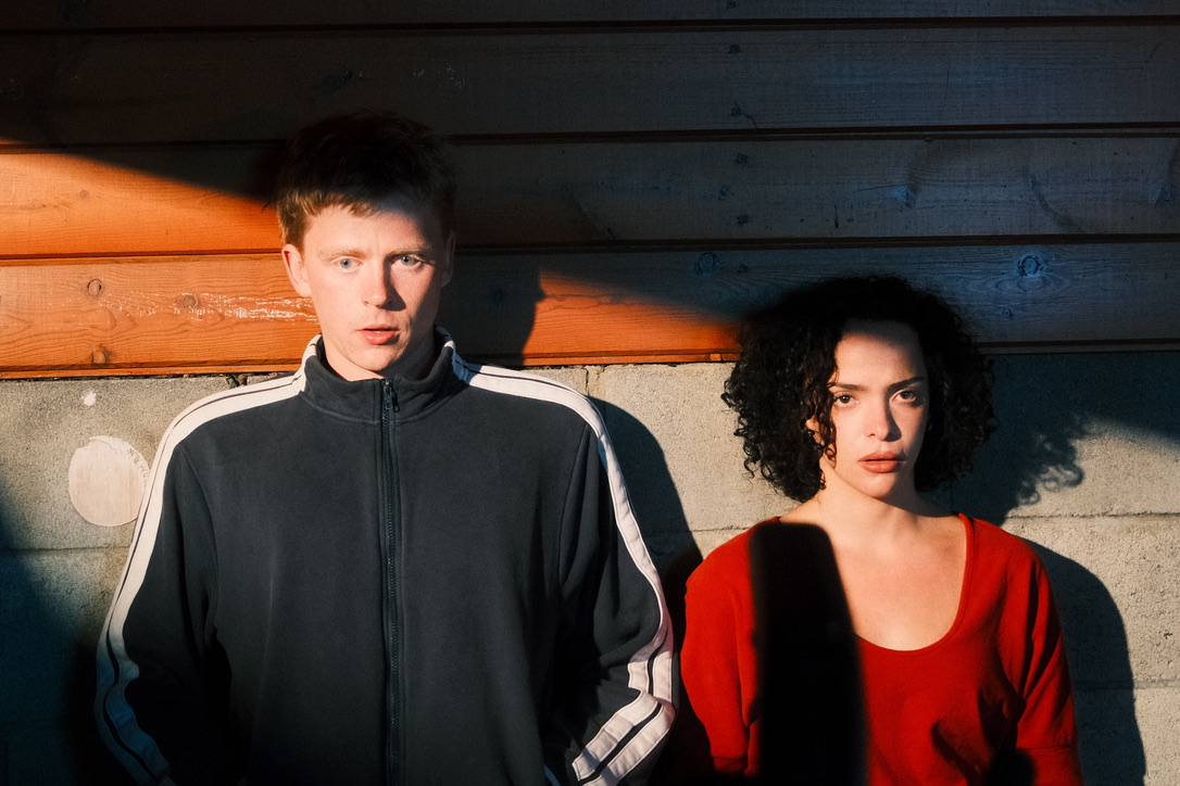 Portrait, two people against a wall