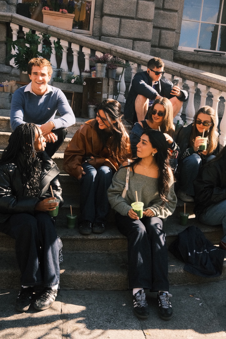 Group of friends laughing on stone steps