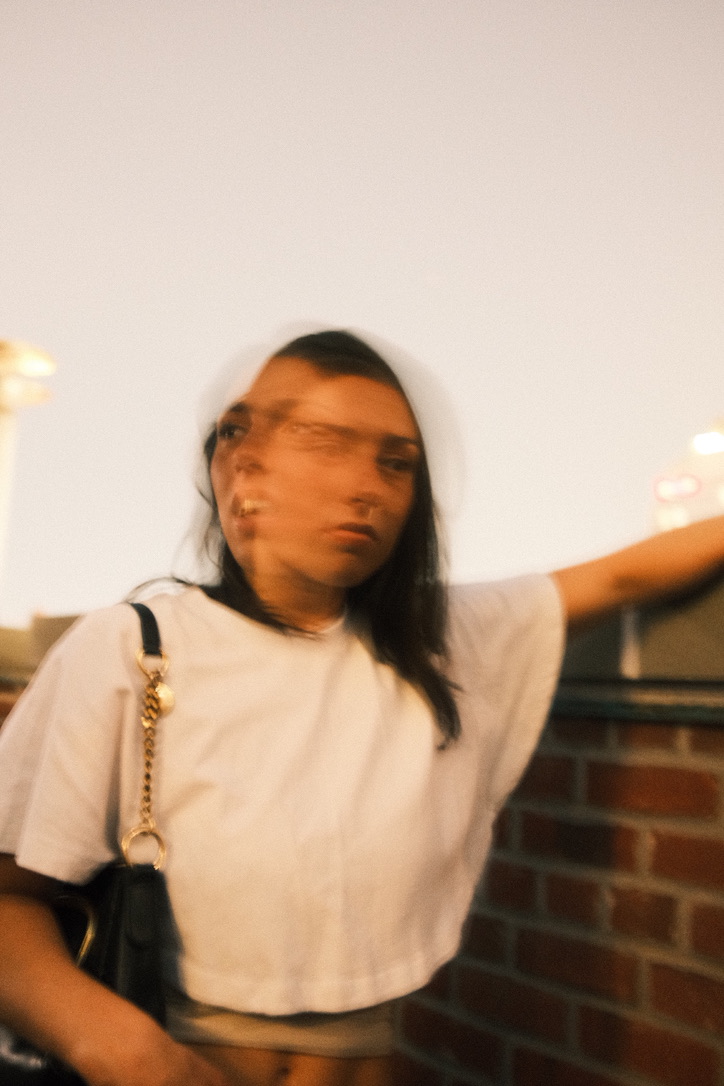 Motion-blur portrait on a rooftop at dusk