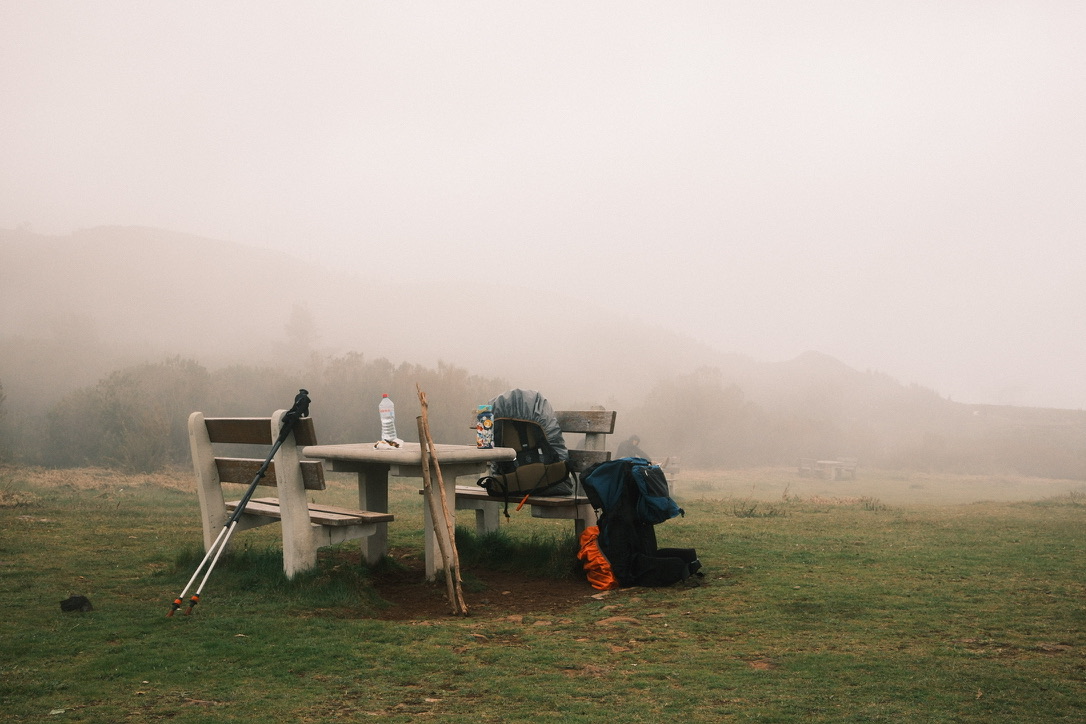 Foggy picnic bench in a field