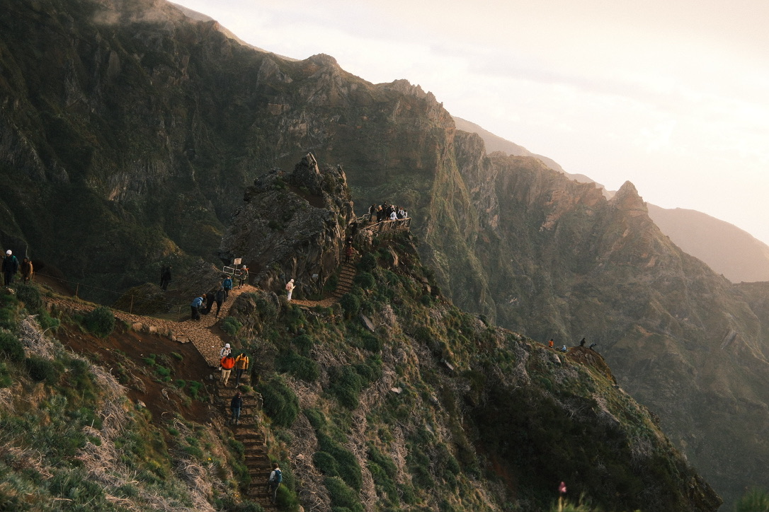 Hikers on a mountain ridge trail