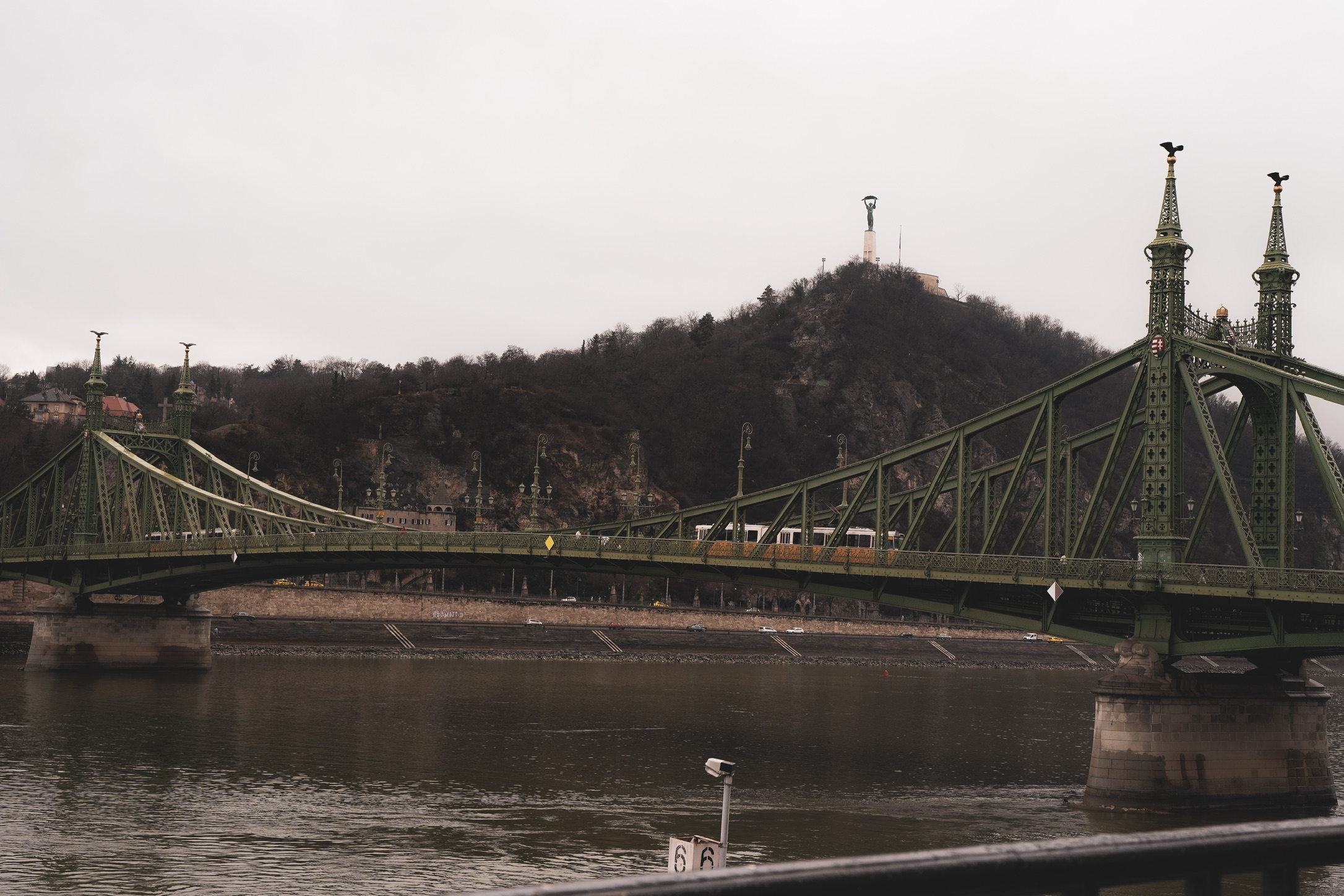 Green iron bridge over a river