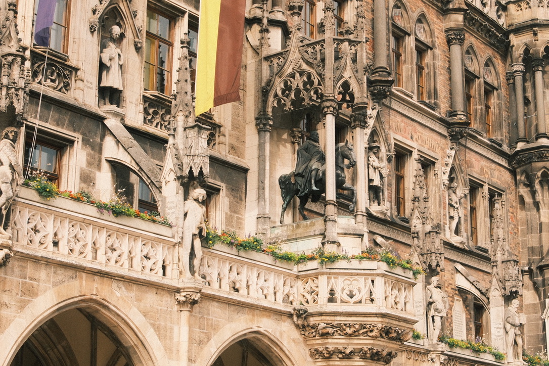 Ornate gothic facade with statues and flags