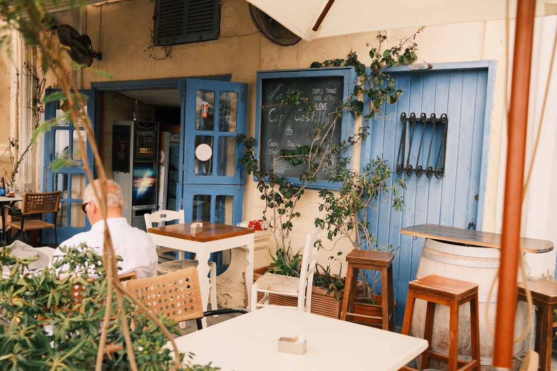 Outdoor cafe seating with blue doors